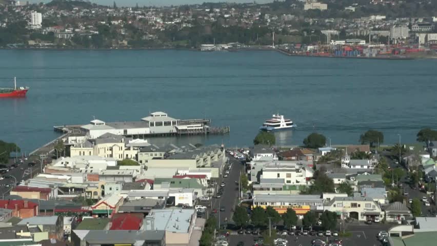 Commercial ship navigating towards Auckland commercial wharf as Passenger ferry