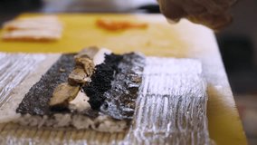 Chef prepares sushi rolls, cooking. Close-up. 4k footage.
