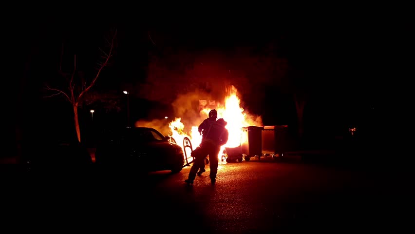 Firefighters suffocating a dumpster | Shutterstock HD Video #25523456