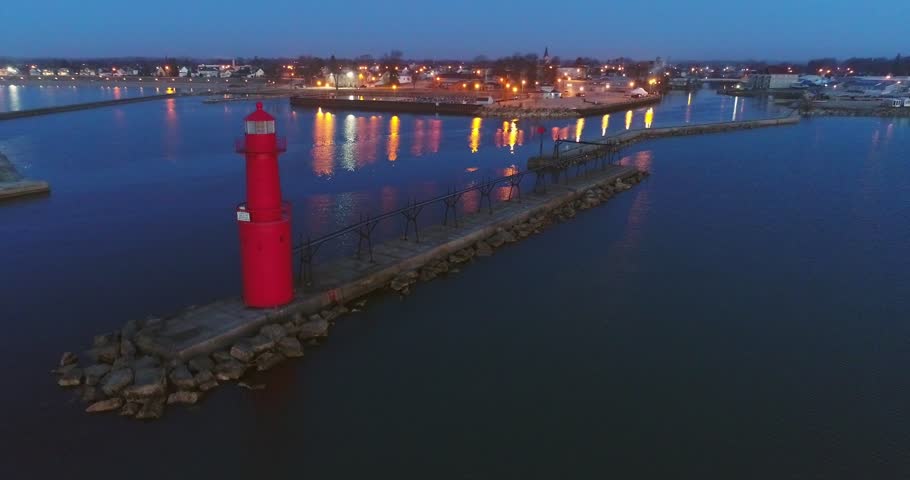Red Lighthouse with city lights twinkling in the distance, Algoma, Wisconsin.
