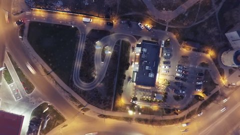 Fast-food restaurant in Time-lapse from a drone. Aerial view of cars and buyers in a trail for buying some food or get some services. Nice optimization for avoiding jams and getting perfect workflow.