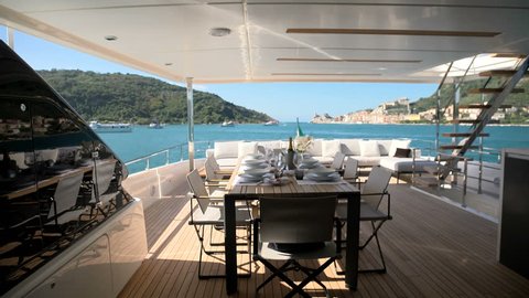 Dining area on a luxury yacht docked in the bay in front of Portovenere, Italy
