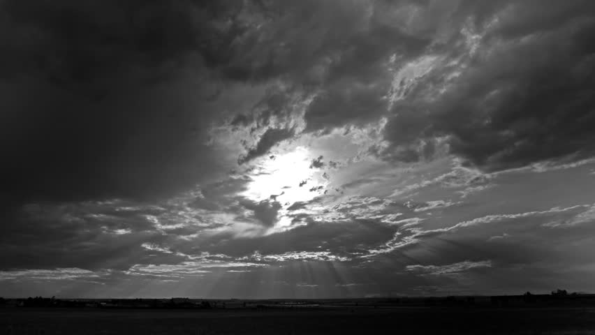 Monotone HD video footage of Storm Clouds backlit by the evening sun. HD 1080p