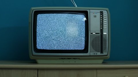 Static noise on a vintage TV set in a dim room