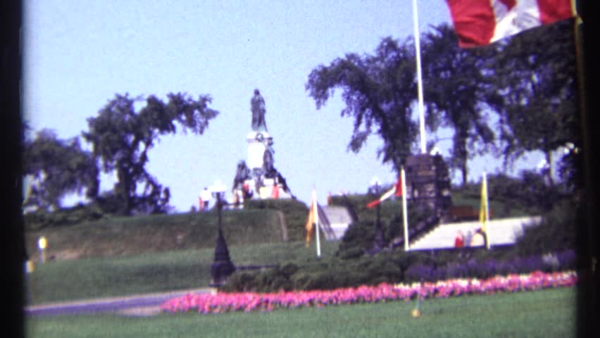 OTTAWA CANADA 1967: a beautiful garden and a statue center of the garden a man walking there and flowers are good