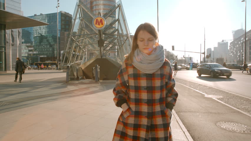 Lady Walking in the City Center and texting on her Smartphone