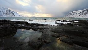 Ancient stones on the shores of cold Norwegian Sea at evening time. Lofoten islands. Beautiful Norway landscape. Slow Motion HD Footage.
