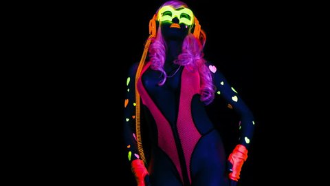 4k fantastic video of sexy cyber raver woman filmed in fluorescent clothing under UV black light.