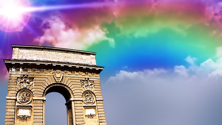 Arc de Triomphe in Paris with time lapse clouds and rainbow