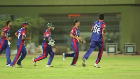 Players celebrating a win after a cricket match in a stadium, Karachi, Pakistan, 