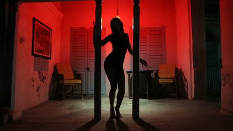 Sexy Woman Silhouette Dancing at the Hotel. Pole Dancer female Stripper in the Night brothel. Sensual Red light, noir style. Beautiful Dancing Girl with Sexy Body. Romantic Private dance, striptease. 
