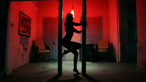 Sexy Woman Silhouette Dancing at the Hotel. Pole Dancer female Stripper in the Night brothel. Sensual Red light, noir style. Beautiful Dancing Girl with Sexy Body. Romantic Private dance, striptease. 