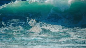 Ocean wave in slow motion, big huge giant extreme surf sea wave, break, crash, spray, splash of waves water. Blue wave nature power background. Epic rough big storm barrel ocean wave slow crash video