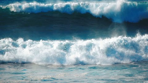 Ocean waves crashing slow motion, surfing blue sea water splashing, spraying coast beach, power of nature storm slomo background. Extreme powerful scenic pacific barrel tubes at north shore of Hawaii