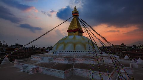 Time lapse day to night of Prayer flags flying on the Boudhanath Stupa. symbol of Kathmandu, Nepal.