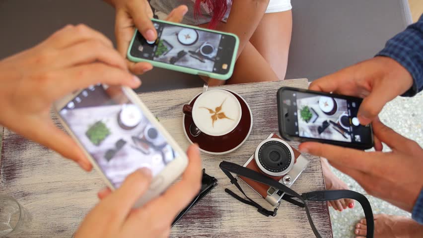 Hipster Hands Taking Pictures with Phone in Coffee Shop