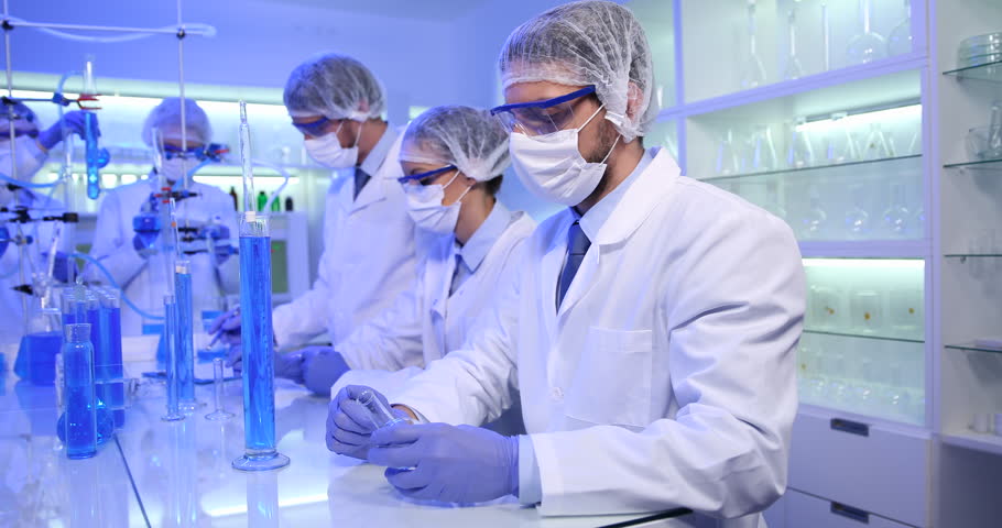Busy Activity in Medical Laboratory Team of Researchers Working with Glassware | Shutterstock HD Video #25572335