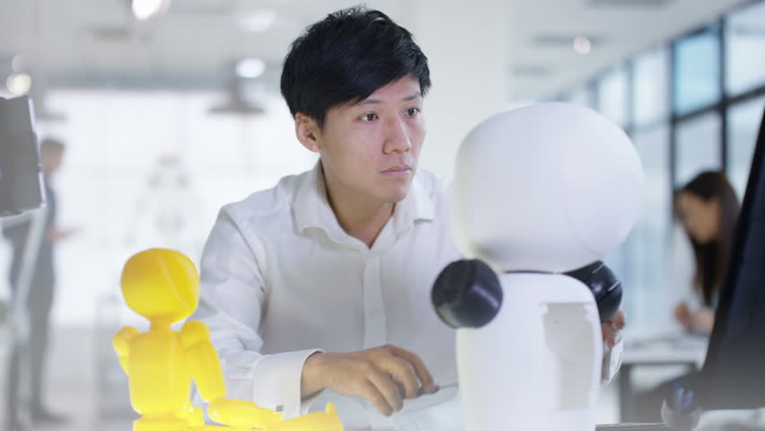4K Asian electronics engineer working in lab with robot prototype