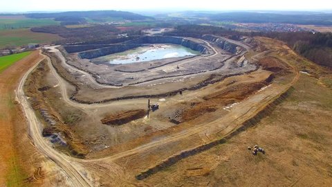 Camera flight over a open cast mine. Industrial landscape. Heavy industry from above. 