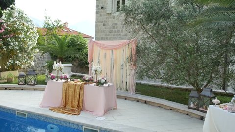 A table at the wedding banquet near the pool. Wedding decorations. Wedding at the sea in Montenegro.