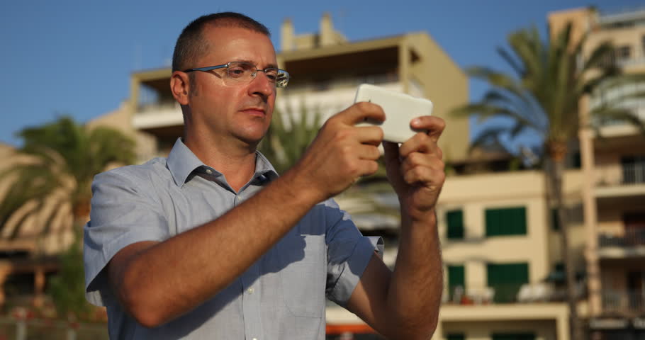Man Sending a Message to Friend on Mobile Phone Exotic Island Vacation Holidays