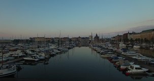 Aerial view drone footage of Helsinki Baltic Sea  lagoon area, city skyline with vintage architecture and boats in summer evening, the capital of Finland, northern Europe