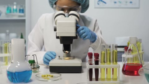 Female lab assistant doing biochemical research, experimental medicine