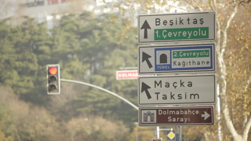 Street signs and a traffic light in Istanbul (Translations: Besiktas, 1st Freeway, Tunnel, 2nd Freeway, Kagithane, Macka, Taksim, Dolmabahce Palace)