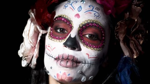 beautiful woman with custom designed candy skull mexican day of the dead face make up