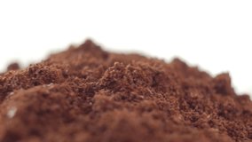 Fine ground coffee powder pile close-up shallow DOF. The slow rotation.
