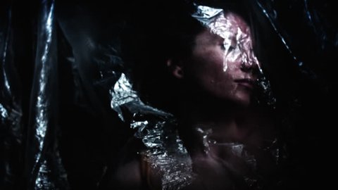 4K Horror Shot Of Dead Woman Waking up in Plastic Bag