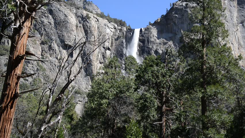 Bridalveil Falls in Yosemite in Spring swollen with snowmelt, where tall granite peaks and green valleys make for an idyllic setting despite global warming concerns, Yosemite National Park, California
