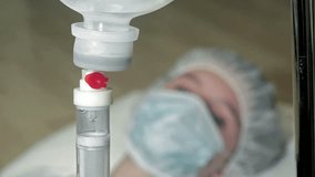 4K intravenous saline drip with patient face out of focus. UHD stock video
