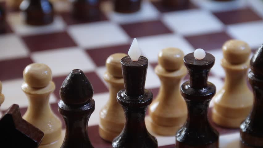 Chessboard with black chess pawns with other white chess pieces and vice versa on the golden background. Funny reverse spy concept. Rotating footage. Royalty-Free Stock Footage #25640141
