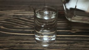 Poured a glass of vodka, close-up . Full hd video