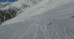 Aerial photography of a snowboarder on a mountainside. Video in 4K
