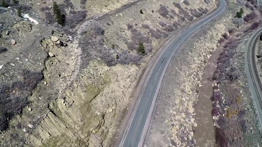 Aerial-Mountain traffic on two lane US highway 6 through Price canyon, Utah paralleling the Price River and empty railroad tracks
