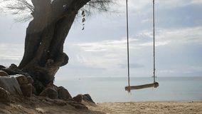 Tropical Island Beach Tree Swing. Peaceful Sea View Background. HD Slowmotion. Koh Phangan, Thailand.