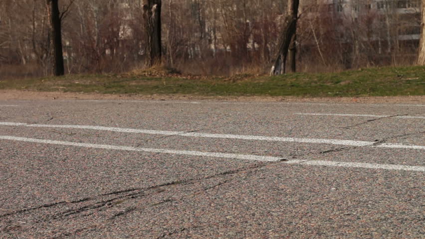A woman in a long skirt and a cyclist are walking along the road,walking feet on pavement.. People walk on the pedestrian road.