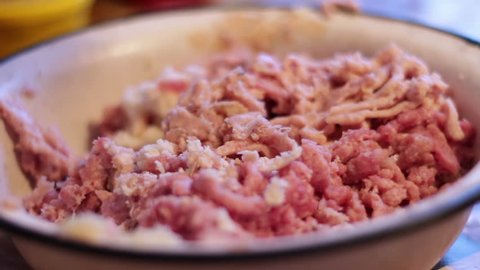 Putting minced meat and vegetable mixture through mincer at home.Cooking the meat forcemeat using the meat grinder,Butcher meat grinding using grinder mincer.