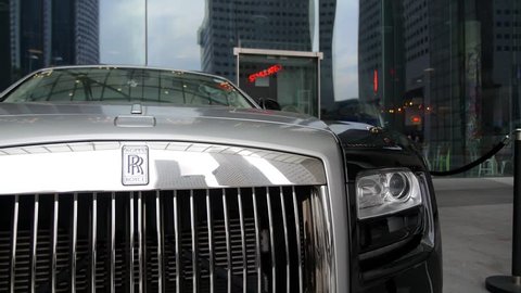 SINGAPORE, JULY 23, 2016 - Rolls Royce Luxury Car on Street of Big City