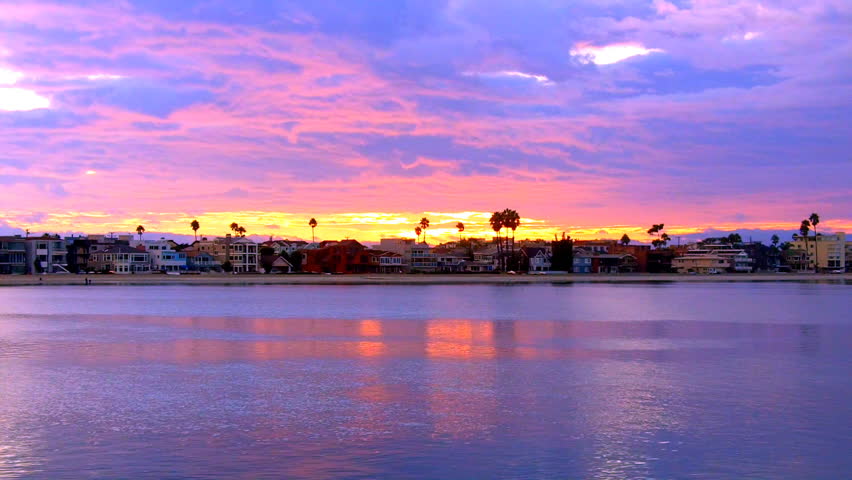 The sun sets over California Beach Houses and Alamitos Bay in Long Beach, CA;
