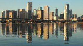 Downtown cityscape of Miami, Florida at dawn with building reflection on water