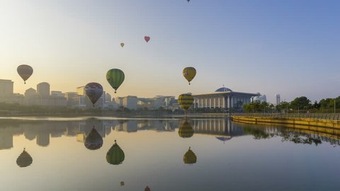 Hot Air Balloons floats across the Putrajaya Lake with calm reflection overlooking the Iron Mosque during the Hot Air Balloon Festival 2017, Putrajaya, Malaysia. Time lapse. Arkivvideo