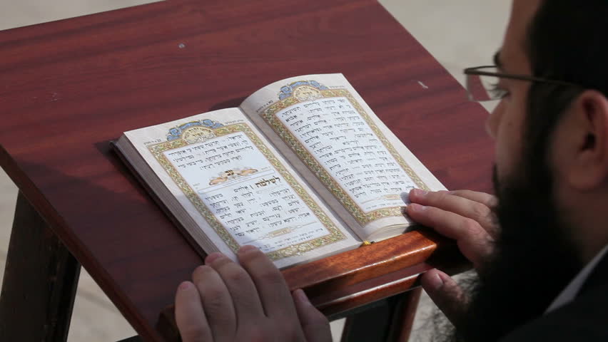 JERUSALEM, ISRAEL - CIRCA MAY 2011: Reading a prayer book at the Wailing wall, referred to as the Western wall or Kotel