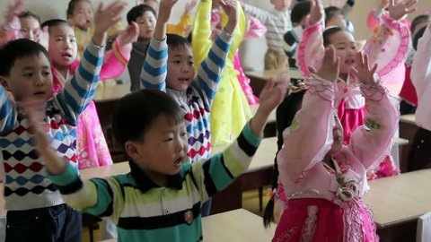 PYONGYANG, NORTH KOREA - CIRCA MAY 2011: school children singing in a classroom