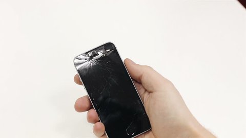 A man holding a broken phone