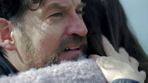 Sad man in love hugging girlfriend crying slow motion profile closeup