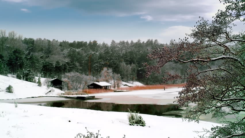Winter scene with two cottages and lake,time-lapse clouds and smoke coming out