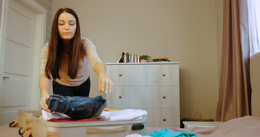 woman packing suitcase